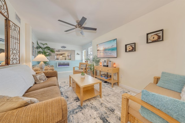 living area featuring visible vents, ceiling fan, and baseboards