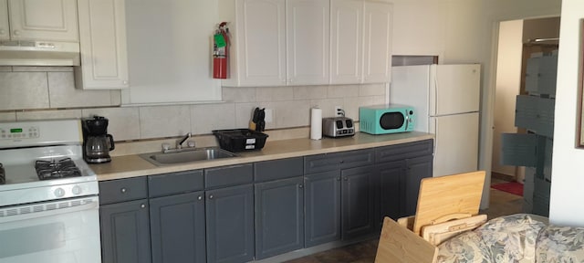 kitchen with white appliances, sink, exhaust hood, white cabinets, and gray cabinets