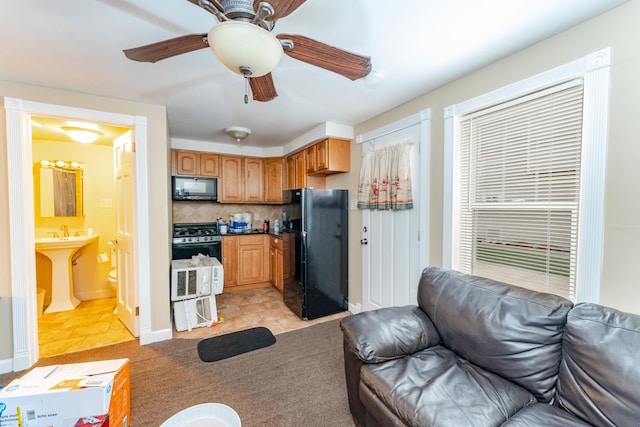 living room featuring sink and light tile patterned floors