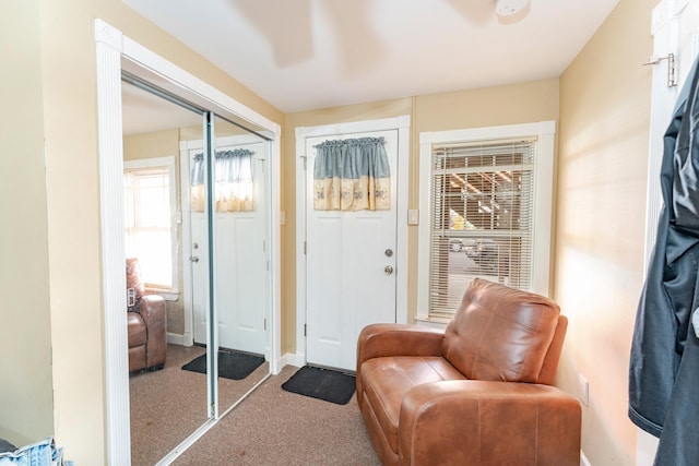 sitting room featuring light colored carpet