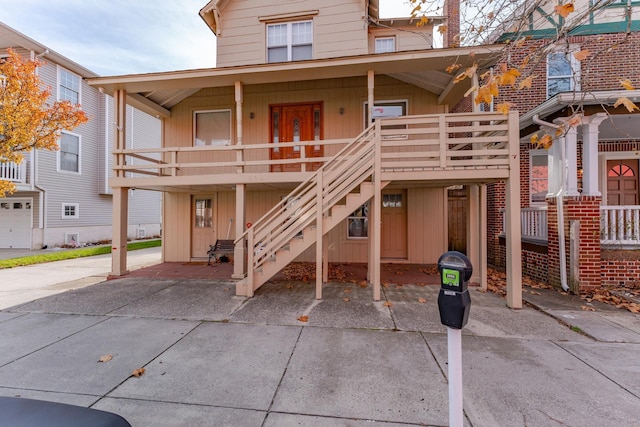 back of property with covered porch