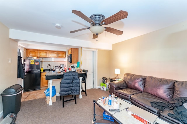 carpeted living room with ceiling fan and sink