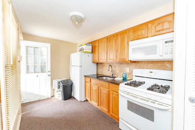 kitchen with decorative backsplash, sink, carpet, and white appliances