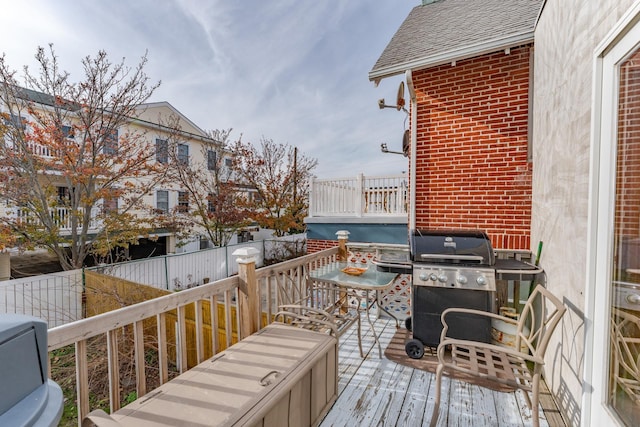 wooden terrace featuring grilling area