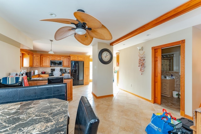 kitchen with ceiling fan, light tile patterned floors, and black refrigerator with ice dispenser