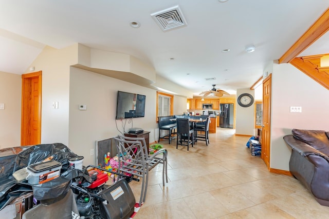 living room with ceiling fan and light tile patterned flooring