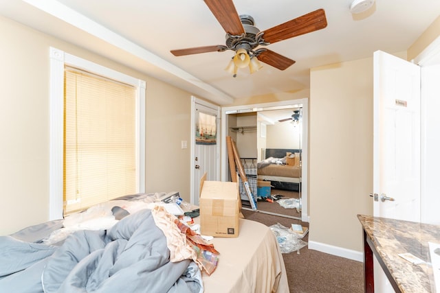 carpeted bedroom with ceiling fan and a closet