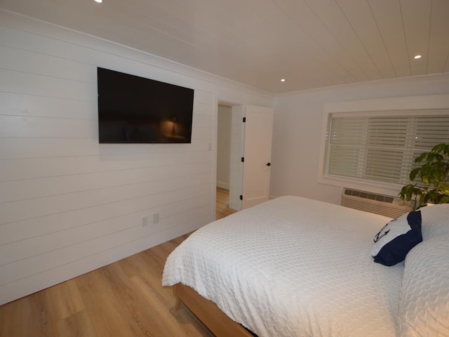 177 80th St Unit 104, Avalon, NJ 08202 - bedroom with light wood-type flooring, recessed lighting, a wall unit AC, wood walls, and ornamental molding