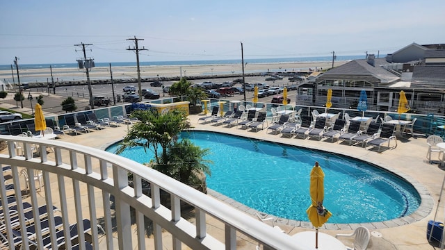 pool with a patio area and fence