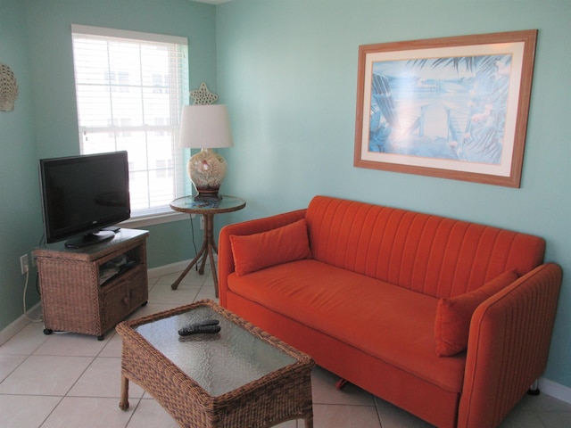 living room featuring light tile patterned flooring and baseboards