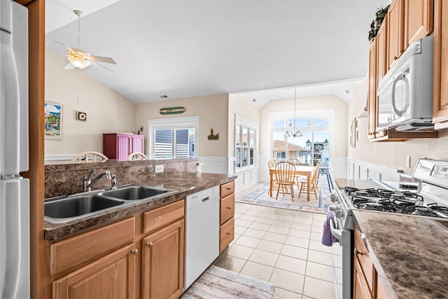 216 E Roberts Ave Unit 7, Wildwood, NJ 08260 - kitchen with white appliances, vaulted ceiling, ceiling fan, a wainscoted wall, and dark countertops