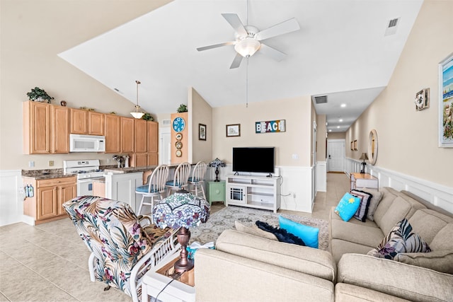 216 E Roberts Ave Unit 7, Wildwood, NJ 08260 - living room featuring a wainscoted wall, a ceiling fan, light tile patterned floors, high vaulted ceiling, and a decorative wall