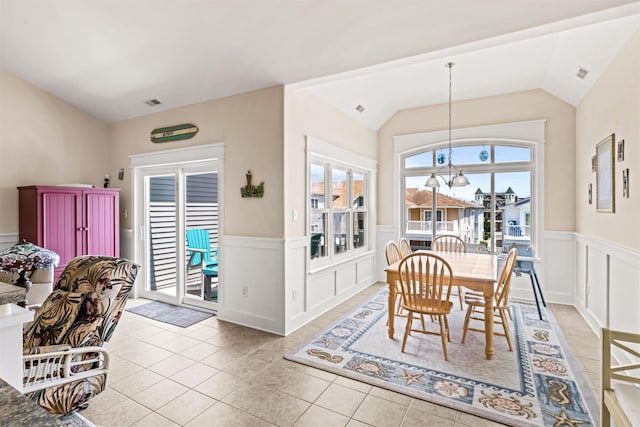 216 E Roberts Ave Unit 7, Wildwood, NJ 08260 - dining area featuring wainscoting, tile patterned floors, a decorative wall, lofted ceiling, and a chandelier