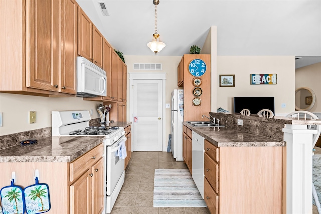 216 E Roberts Ave Unit 7, Wildwood, NJ 08260 - kitchen featuring white appliances, dark countertops, a peninsula, light tile patterned flooring, and a kitchen breakfast bar