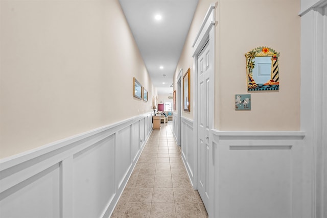 216 E Roberts Ave Unit 7, Wildwood, NJ 08260 - hall with recessed lighting, a decorative wall, wainscoting, and light tile patterned floors