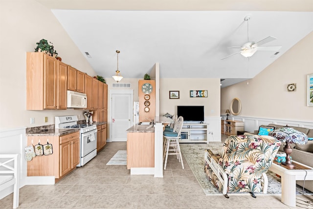 216 E Roberts Ave Unit 7, Wildwood, NJ 08260 - kitchen featuring white appliances, vaulted ceiling, open floor plan, ceiling fan, and a kitchen bar