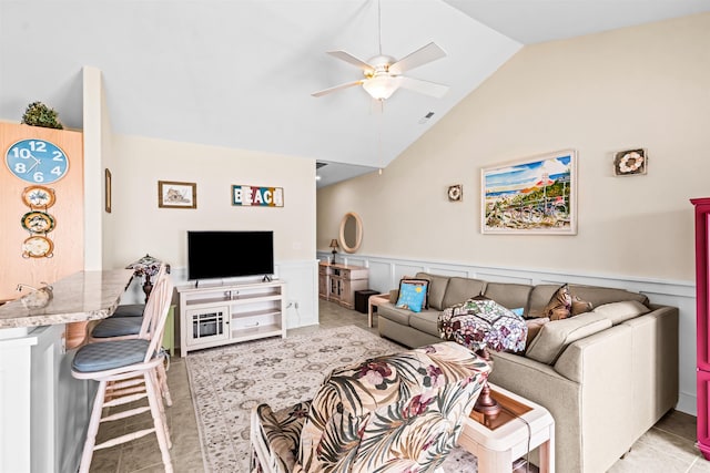 216 E Roberts Ave Unit 7, Wildwood, NJ 08260 - living room featuring ceiling fan, wainscoting, vaulted ceiling, a decorative wall, and light tile patterned floors