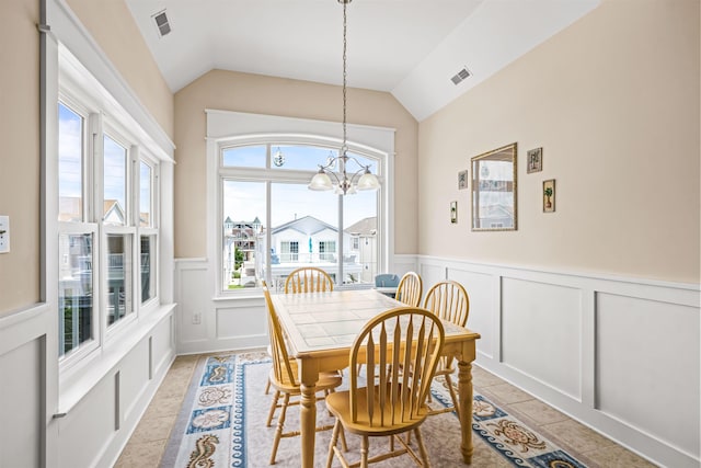 216 E Roberts Ave Unit 7, Wildwood, NJ 08260 - dining room with a decorative wall, a chandelier, a wainscoted wall, and lofted ceiling