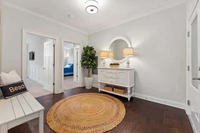 hall featuring ornamental molding and dark hardwood / wood-style floors