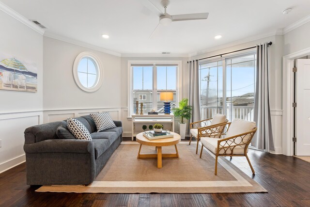 living room featuring ceiling fan, dark hardwood / wood-style flooring, and crown molding