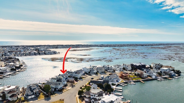 drone / aerial view featuring a residential view and a water view