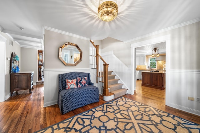 interior space with stairway, a wainscoted wall, and wood finished floors