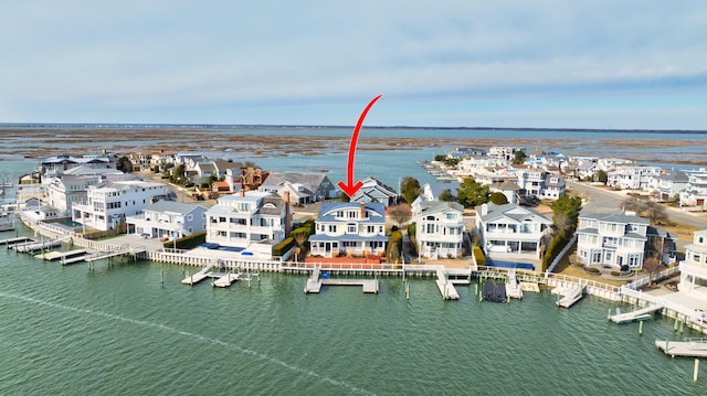 bird's eye view with a water view and a residential view