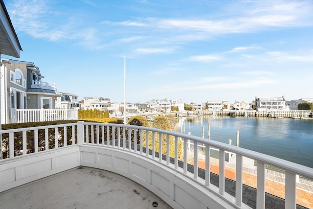 balcony featuring a residential view and a water view