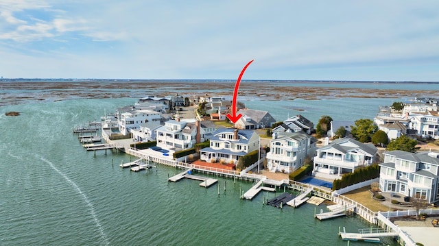 birds eye view of property featuring a water view and a residential view