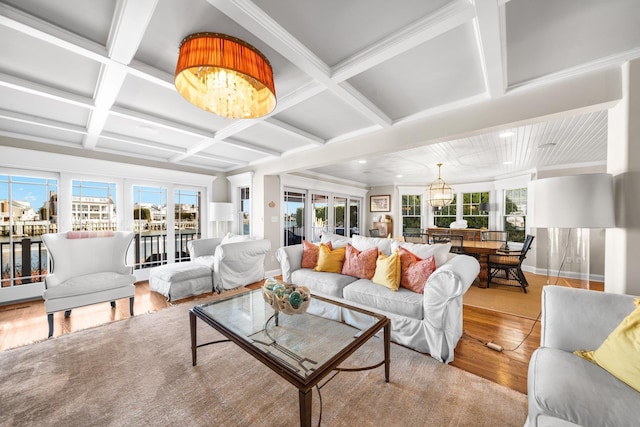 living area with a wealth of natural light, coffered ceiling, and wood finished floors