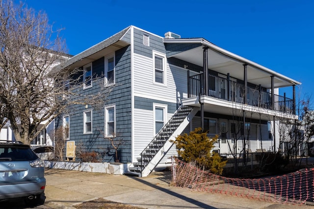 view of side of property featuring a balcony