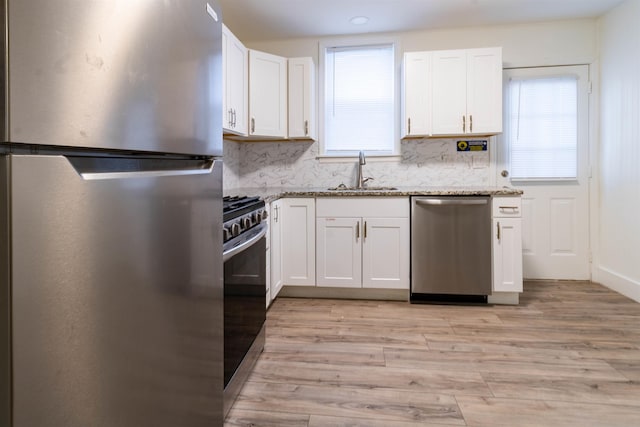 kitchen with white cabinetry, appliances with stainless steel finishes, and sink