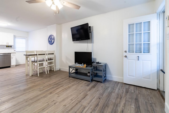 living room featuring ceiling fan and light wood-type flooring