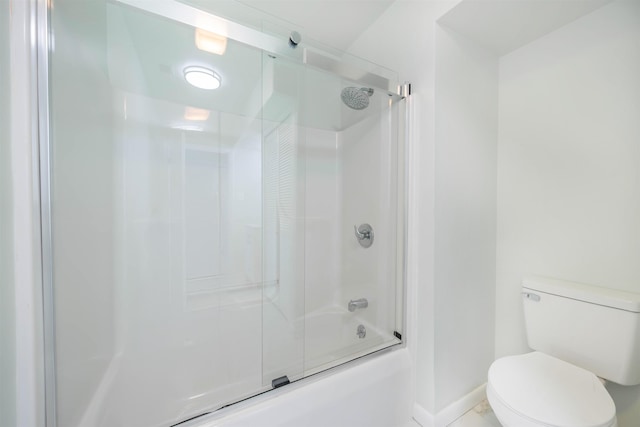 bathroom featuring combined bath / shower with glass door and toilet