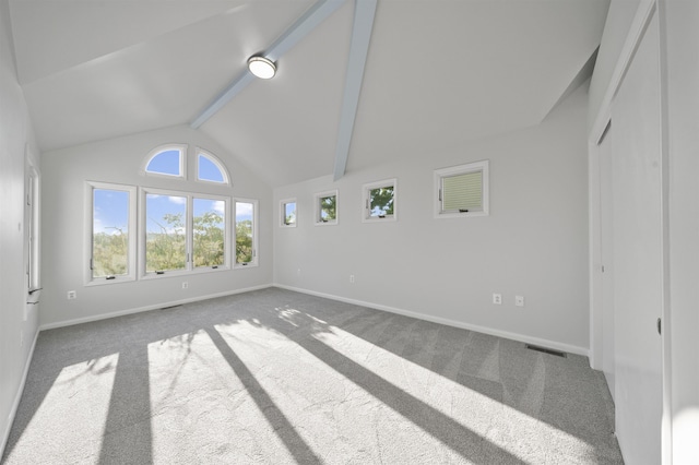 unfurnished living room with beam ceiling, carpet floors, and high vaulted ceiling