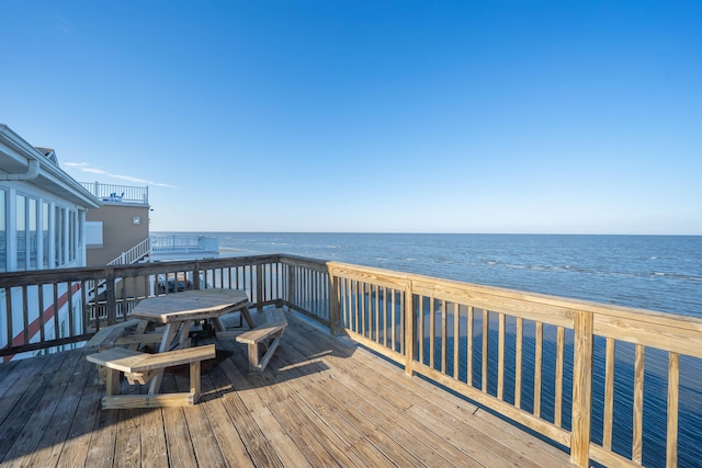 wooden terrace with a water view and a beach view