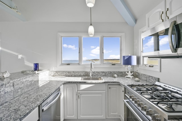 kitchen with sink, appliances with stainless steel finishes, decorative light fixtures, light stone counters, and white cabinetry