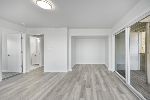 spare room featuring light hardwood / wood-style flooring