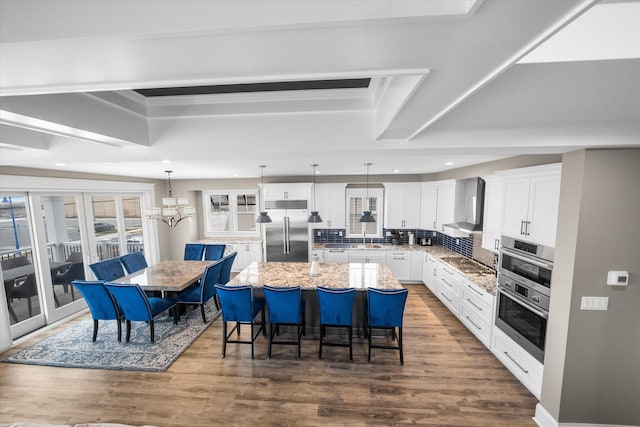 2958 Avalon Ave, Avalon, NJ 08202 - kitchen featuring stainless steel appliances, a center island, recessed lighting, a breakfast bar, and white cabinetry