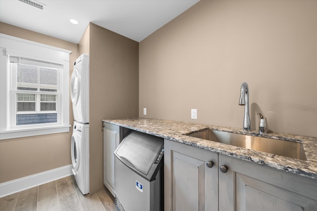 2958 Avalon Ave, Avalon, NJ 08202 - laundry room with stacked washing machine and dryer, light wood finished floors, cabinet space, and recessed lighting