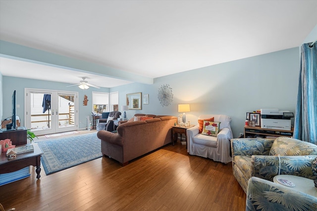 living room featuring french doors, beamed ceiling, wood finished floors, and a ceiling fan