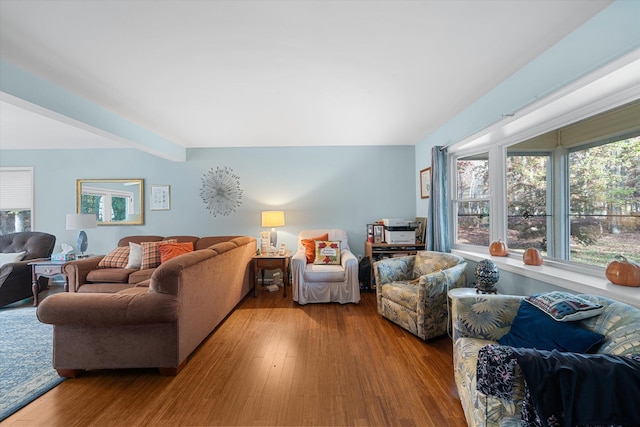 living room featuring wood finished floors and beam ceiling