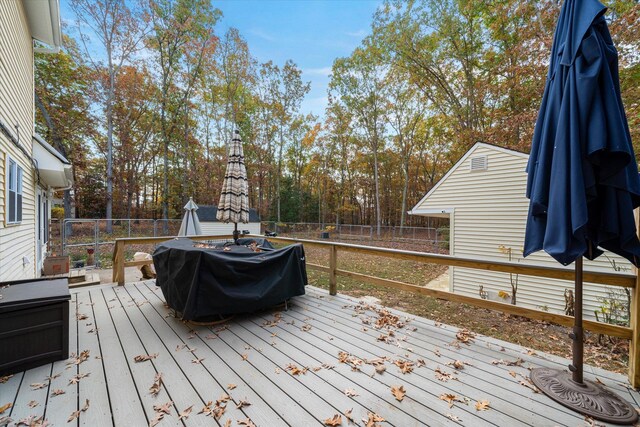 deck featuring a grill and fence