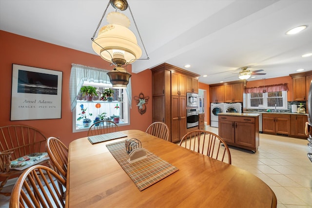 dining area with a healthy amount of sunlight, light tile patterned floors, washing machine and dryer, and recessed lighting