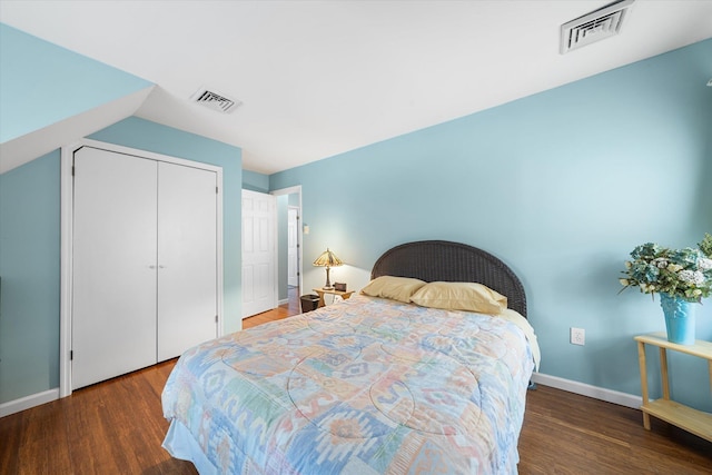 bedroom featuring wood finished floors, visible vents, and baseboards