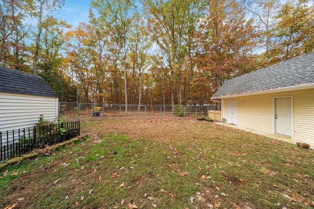 view of yard with an outbuilding and a fenced backyard