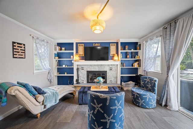 331 Holly Ln, Erma, NJ 08204 - living area featuring built in shelves, a stone fireplace, crown molding, and wood finished floors