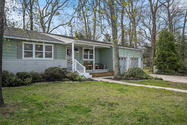 331 Holly Ln, Erma, NJ 08204 - view of front of home featuring driveway, an attached garage, a porch, a front yard, and brick siding