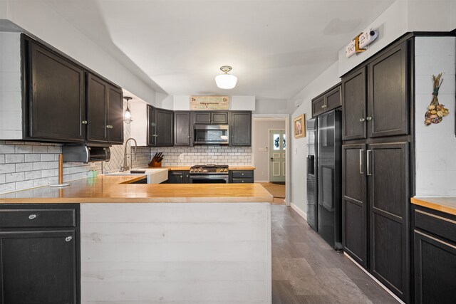 331 Holly Ln, Erma, NJ 08204 - kitchen featuring a peninsula, a sink, dark wood-style flooring, tasteful backsplash, and appliances with stainless steel finishes