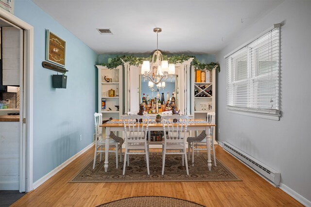 331 Holly Ln, Erma, NJ 08204 - dining area with a baseboard radiator, wood finished floors, an inviting chandelier, baseboards, and visible vents